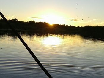 Scenic view of lake against sky at sunset