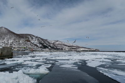 Scenic view of sea against sky during winter