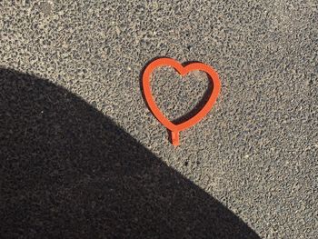 High angle view of heart shape on sand