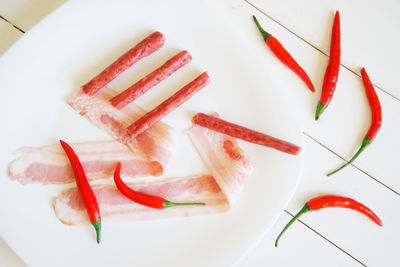 High angle view of red chili peppers in plate on table