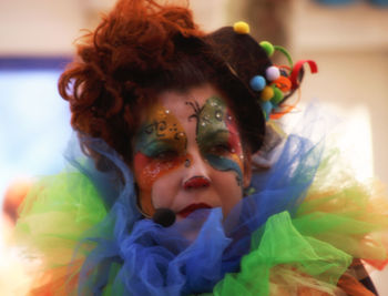 Close-up of mid adult woman in face paint standing outdoors