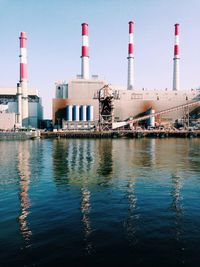 Exterior of factory with smoke stacks by river