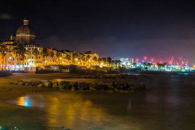 Illuminated buildings in city at night