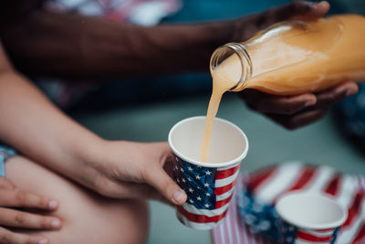 Midsection of man pouring coffee in cup