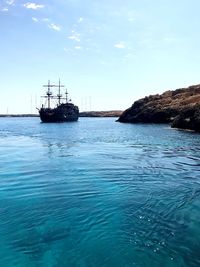 Sailboat on sea against sky