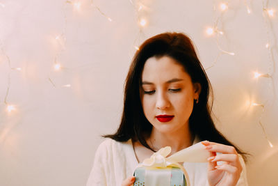 Portrait of young woman sitting on table