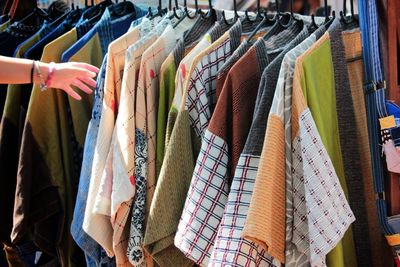 Clothes hanging in row at store