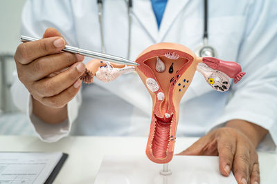 Midsection of doctor examining patient in clinic