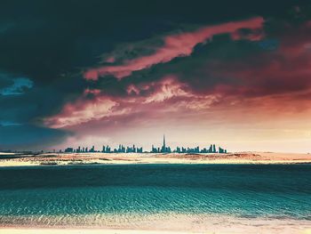 Scenic view of sea against cloudy sky during sunset