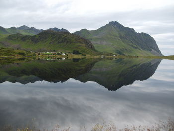 Scenic view of lake and mountains against sky