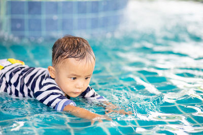 Portrait of boy swimming in pool