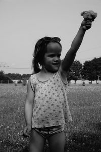 Portrait of a young woman standing on grass