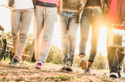 Low section of people standing on land