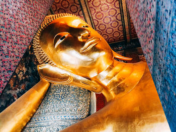 Close-up of buddha statue against building