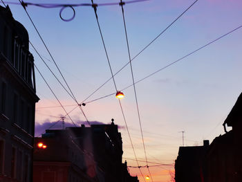 Low angle view of silhouette buildings against sky at sunset