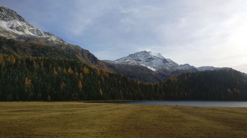 Scenic view of lake and mountains against sky