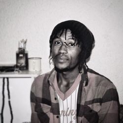 Portrait of smiling young man against wall