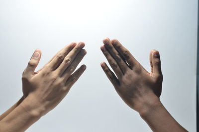 Close-up of hands over white background