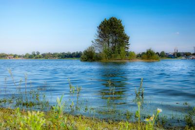 Scenic view of lake against blue sky