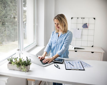 Smiling businesswoman working at office