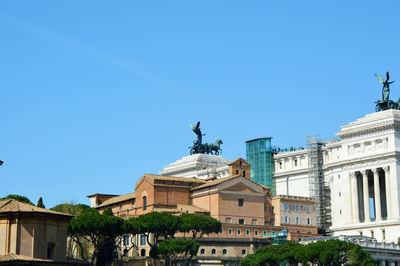 Low angle view of buildings against blue sky