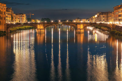 Florence, italy - 20 june, 2019, view of st trinity bridge and river arno at night.