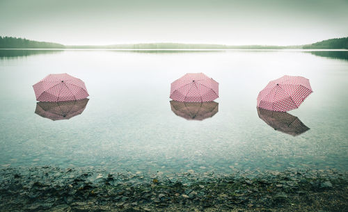 Three umbrellas in shallow water