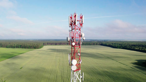 Traditional windmill on field against sky