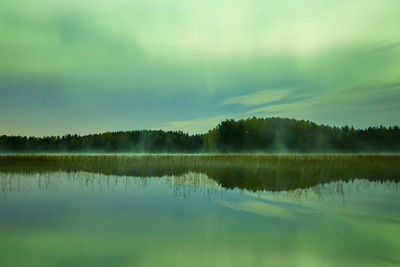 Scenic view of lake against sky at night