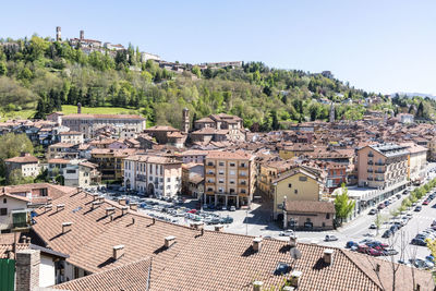 Built structures on landscape against clear blue sky