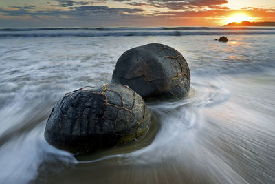 Scenic view of sea against sky at sunset