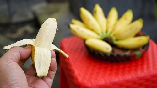 Close-up of hand holding banana