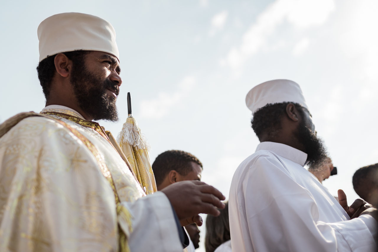 men, real people, celebration, event, traditional clothing, wedding, group of people, life events, low angle view, emotion, sky, celebration event, lifestyles, togetherness, love, adult, people, ceremony, wedding ceremony