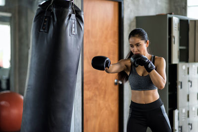 Beautiful woman practicing boxing in gym