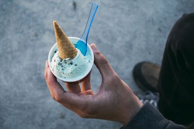 Midsection of man holding ice cream cone