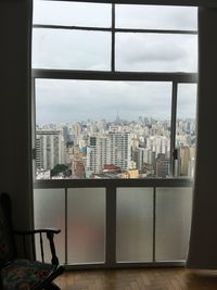 Cityscape against sky seen through window