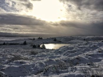 Scenic view of frozen sea against sky during sunset