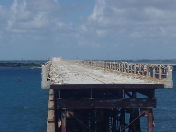 Pier over sea against sky