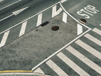 High angle view of arrow sign on road in city