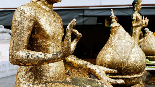 Close-up of buddha statue against temple