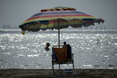 Men swimming in sea at beach