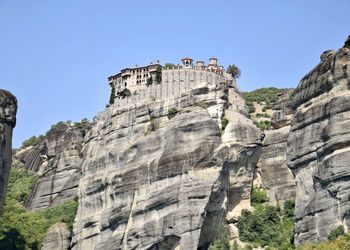 Low angle view of castle on mountain against sky