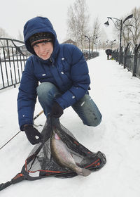 Smiling boy with snow in winter