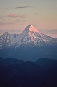 Scenic view of snowcapped mountains against sky during sunset