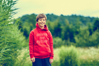 Portrait of boy standing on field