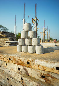 Close-up of stack of construction site against sky