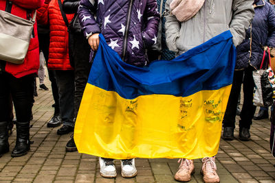 Rear view of people walking on street