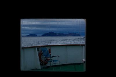 Scenic view of sea against sky seen through window