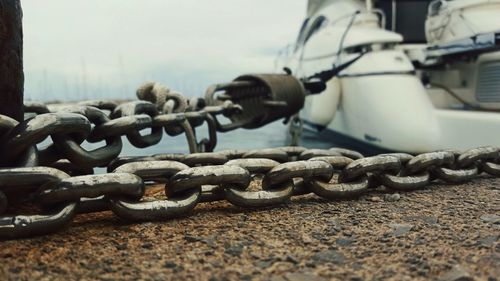 Close-up of metallic chain at harbor