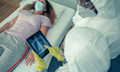 High angle view of woman relaxing on bed